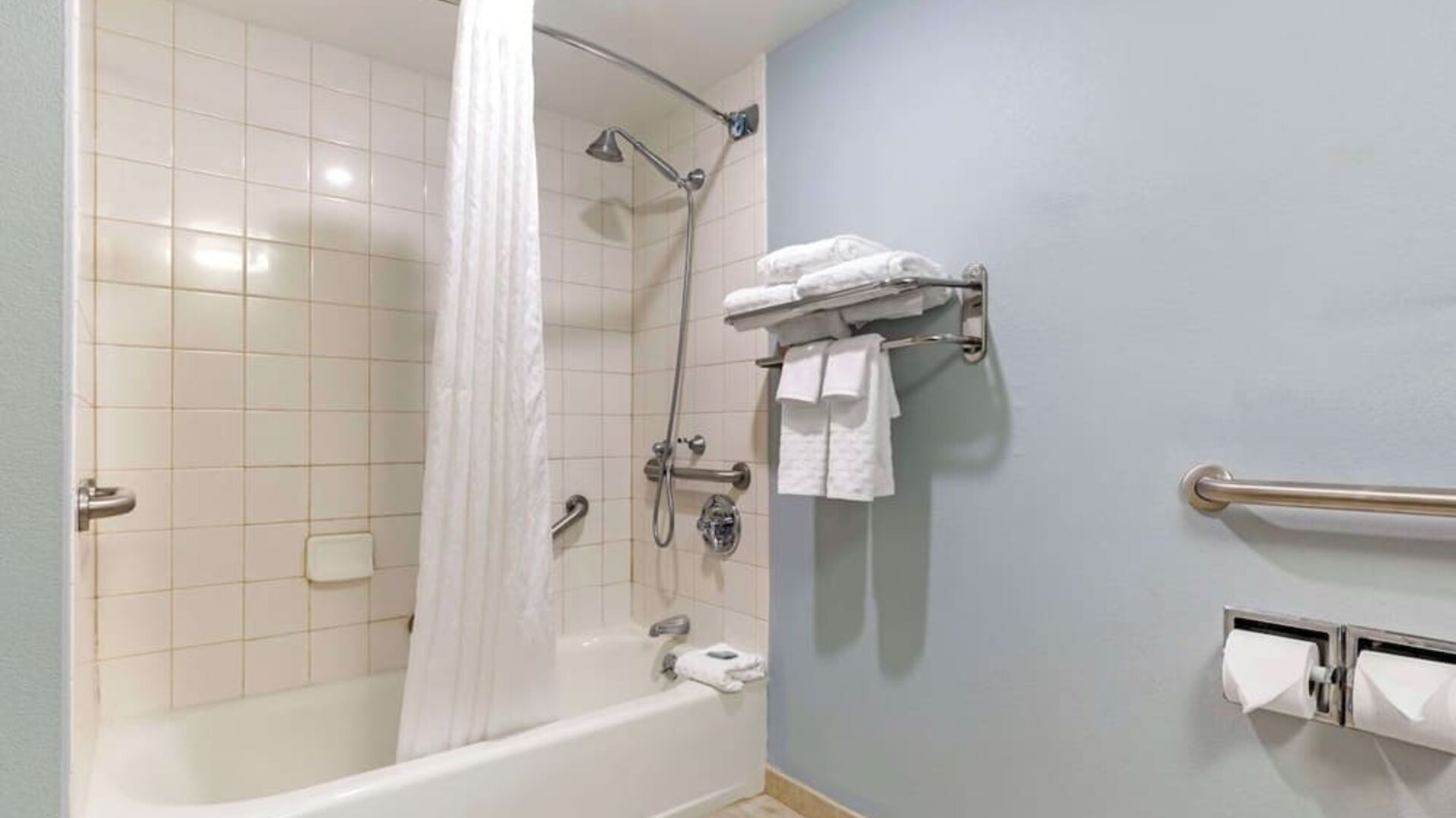 Guest bathroom with shower and tub at Best Western Hartford Hotel & Suites.
