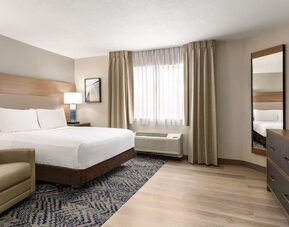 Guest room featuring a king-size bed, contemporary furnishings and a comfortable, relaxing atmosphere at Candlewood Suites Meridian.