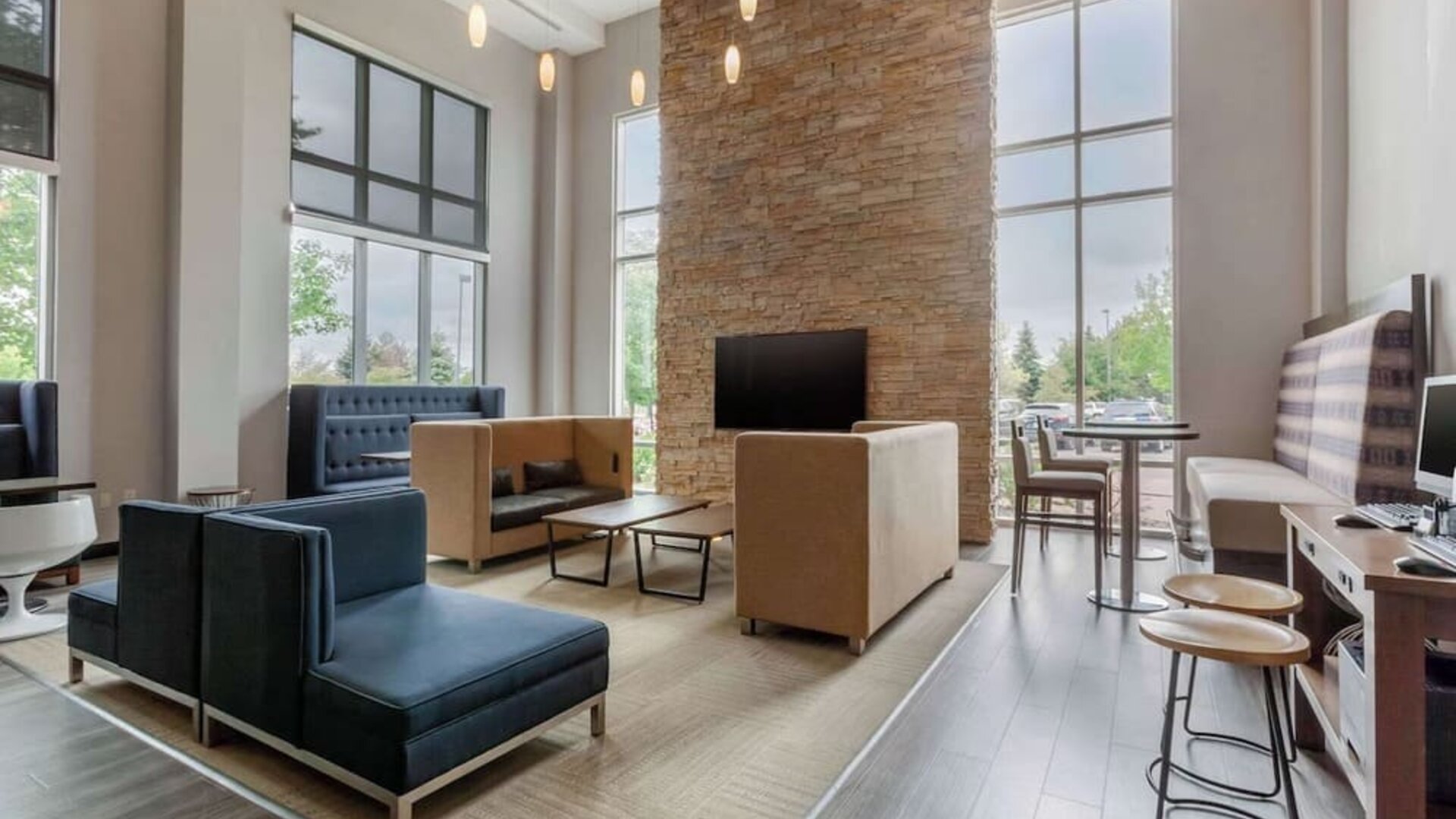 Lobby and coworking lounge at Cambria Suites Denver Airport.