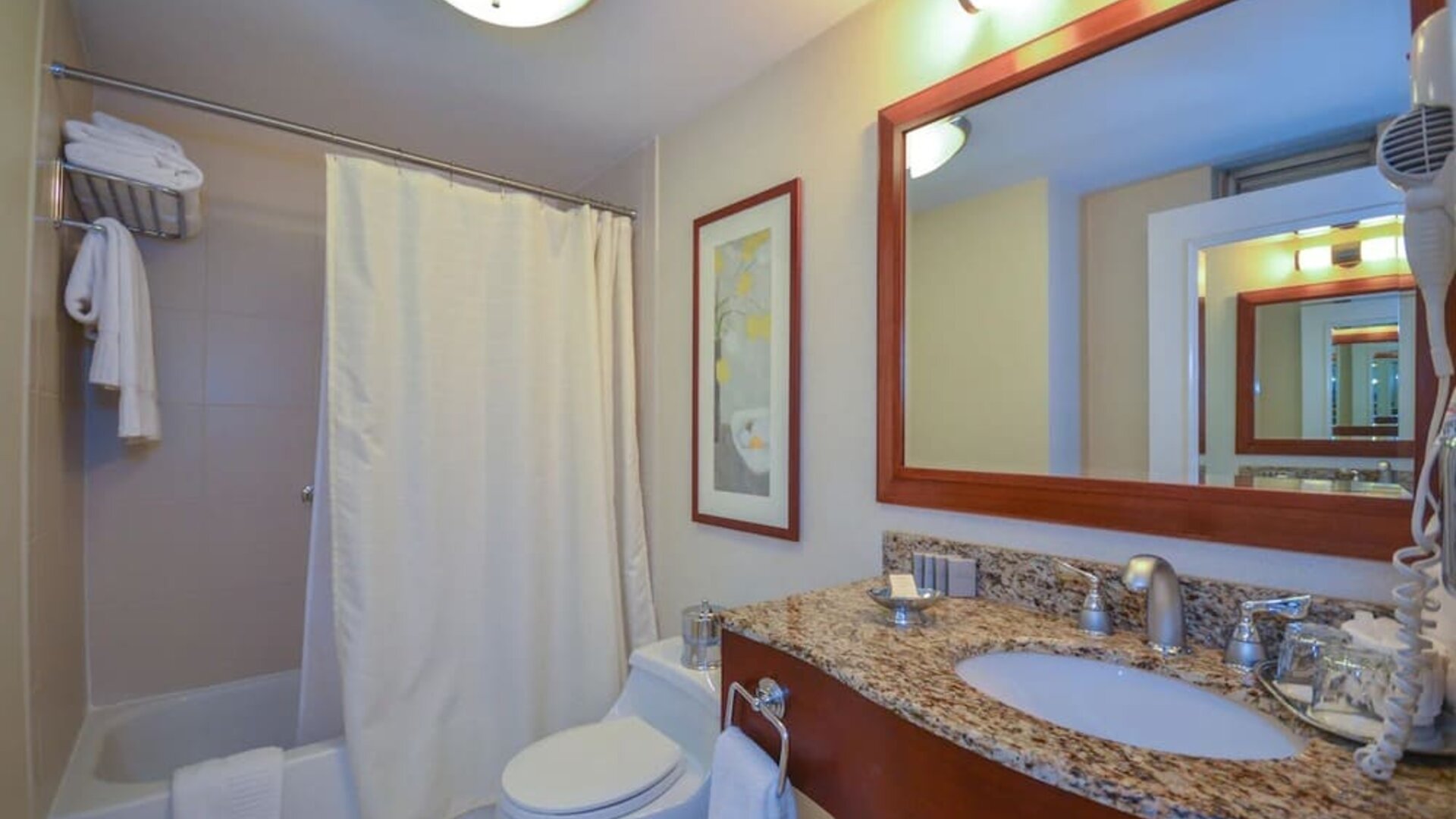 Guest bathroom with shower and tub at San Carlos Hotel.