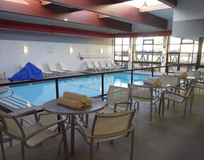 Tables and chairs available beside pool at DoubleTree By Hilton Westborough.