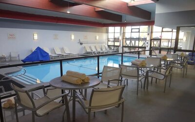 Tables and chairs available beside pool at DoubleTree By Hilton Westborough.