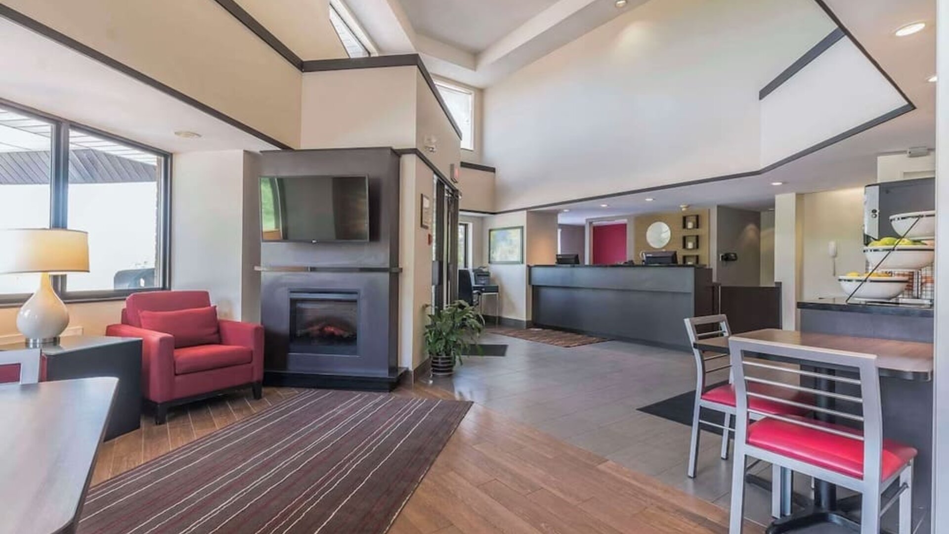 Hotel lobby with lounge area and fireplace at Comfort Inn Cobourg.