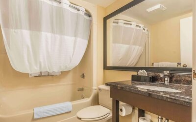 Guest bathroom with tub and free toiletries at Comfort Inn Cobourg.
