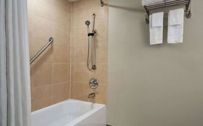 Guest bathroom with shower and tub at Wyndham Garden Pittsburgh Airport.