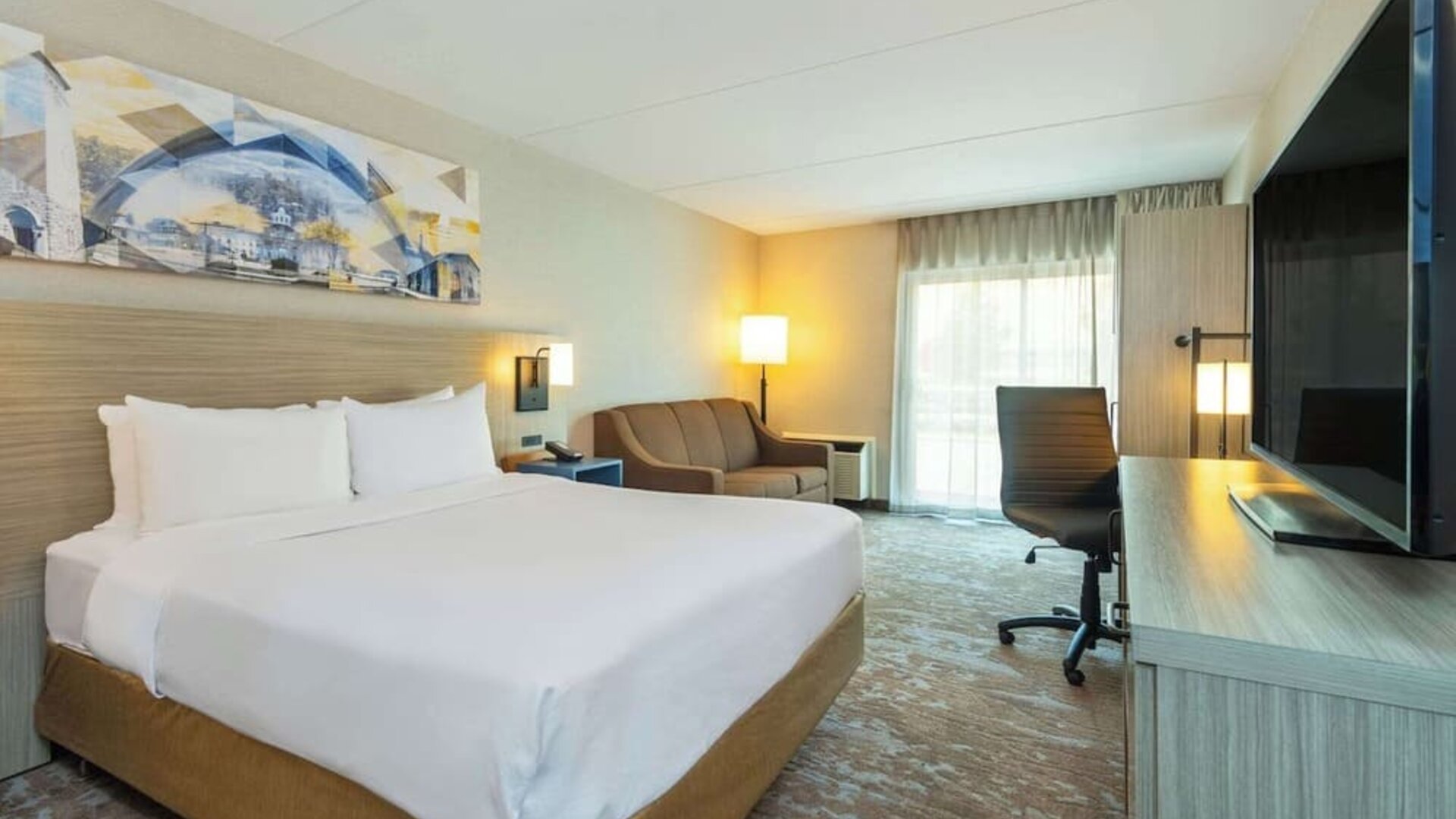 Standard day use room with TV, work desk, sofa and private bathroom at Comfort Inn Kingston HWY 401.