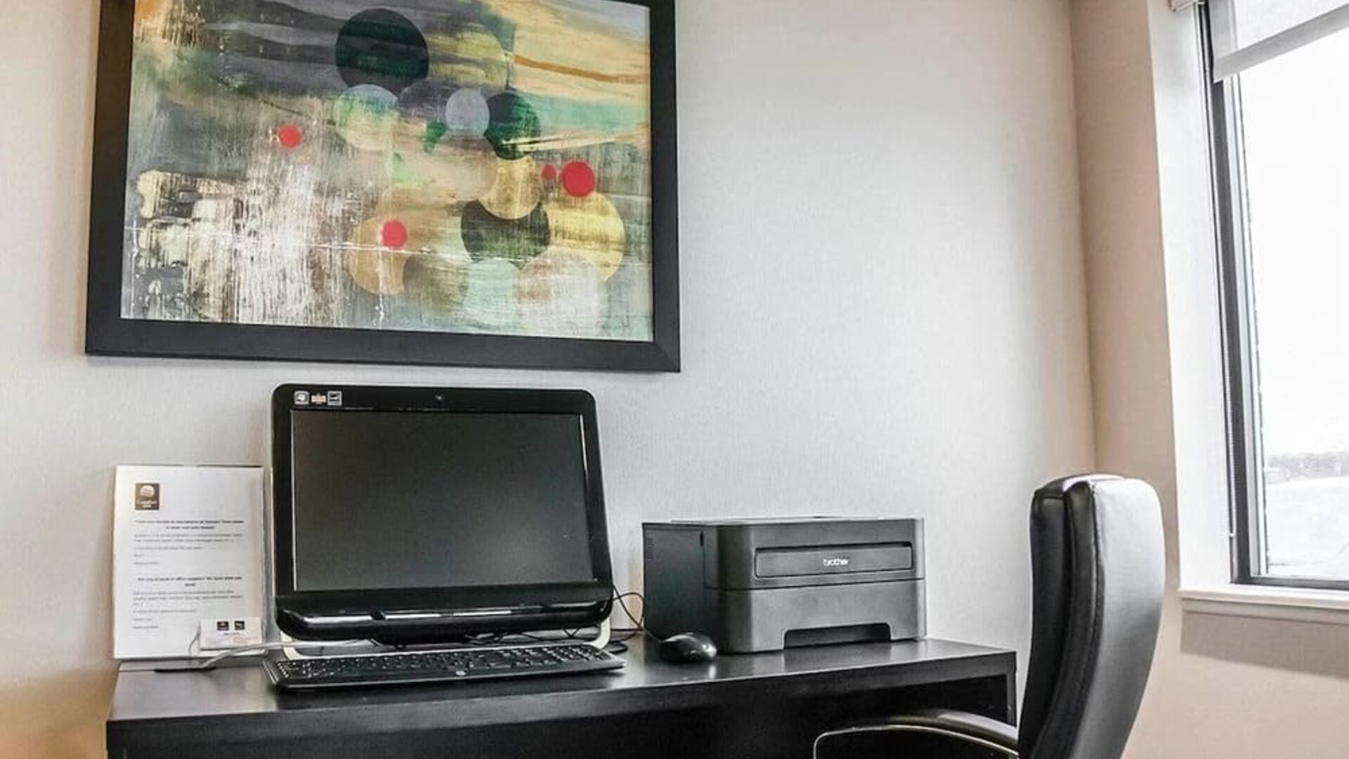 Business center with computer, printer and ergonomic chair at Comfort Inn Laval.