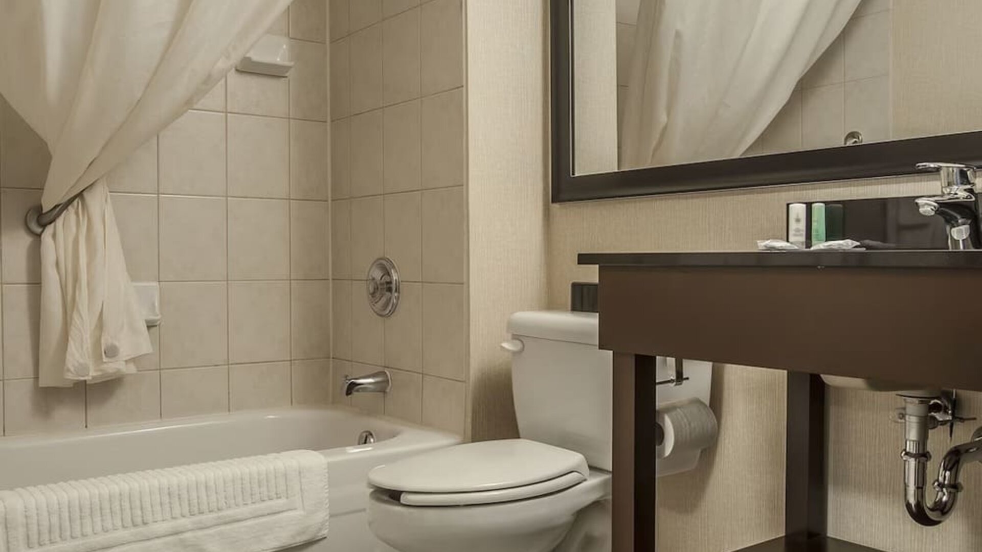 Guest bathroom with tub and free toiletries at Comfort Inn Edmundston.