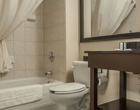 Guest bathroom with tub and free toiletries at Comfort Inn Edmundston.