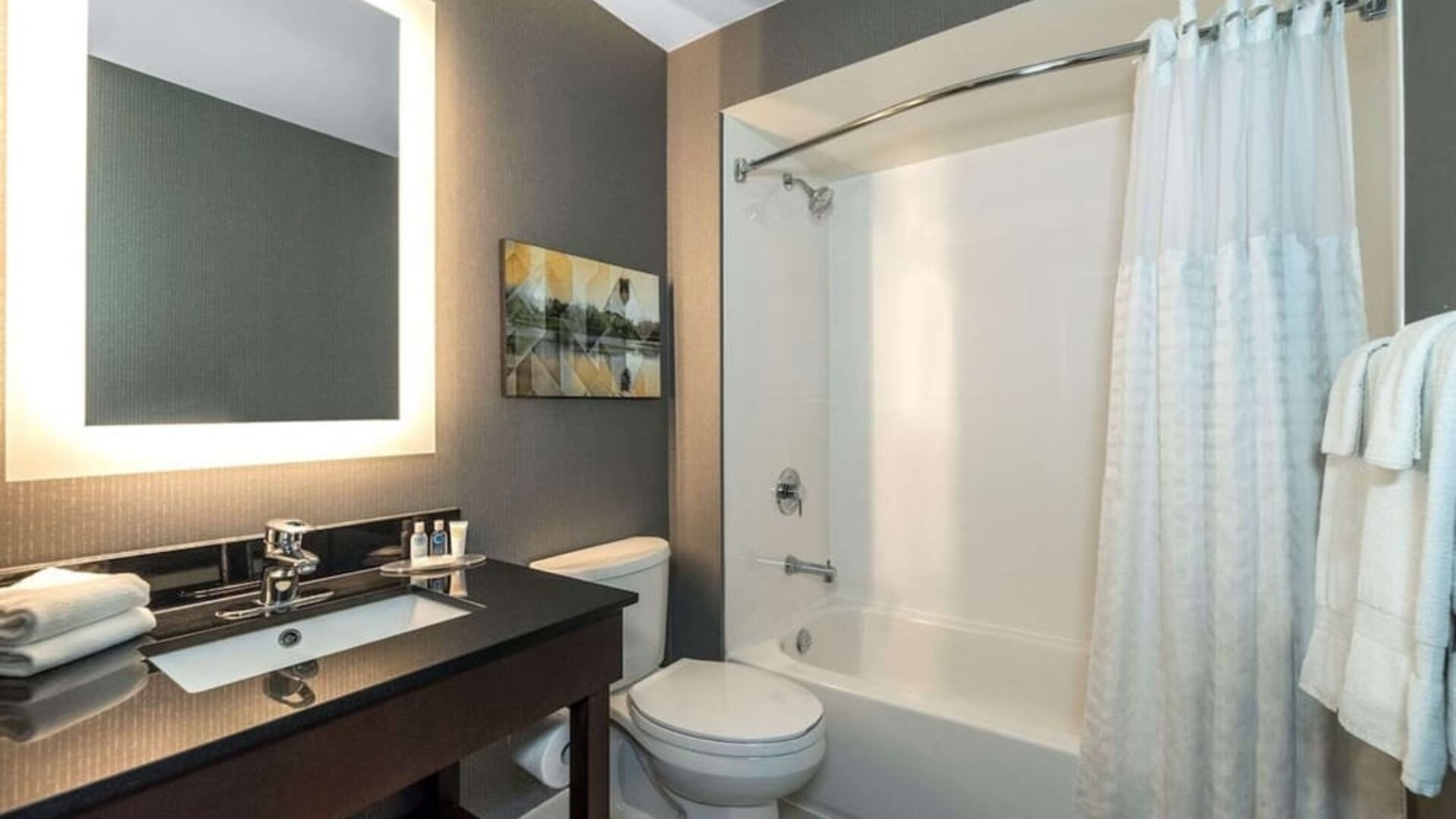 Private guest bathroom with shower and tub at Comfort Inn Dryden.