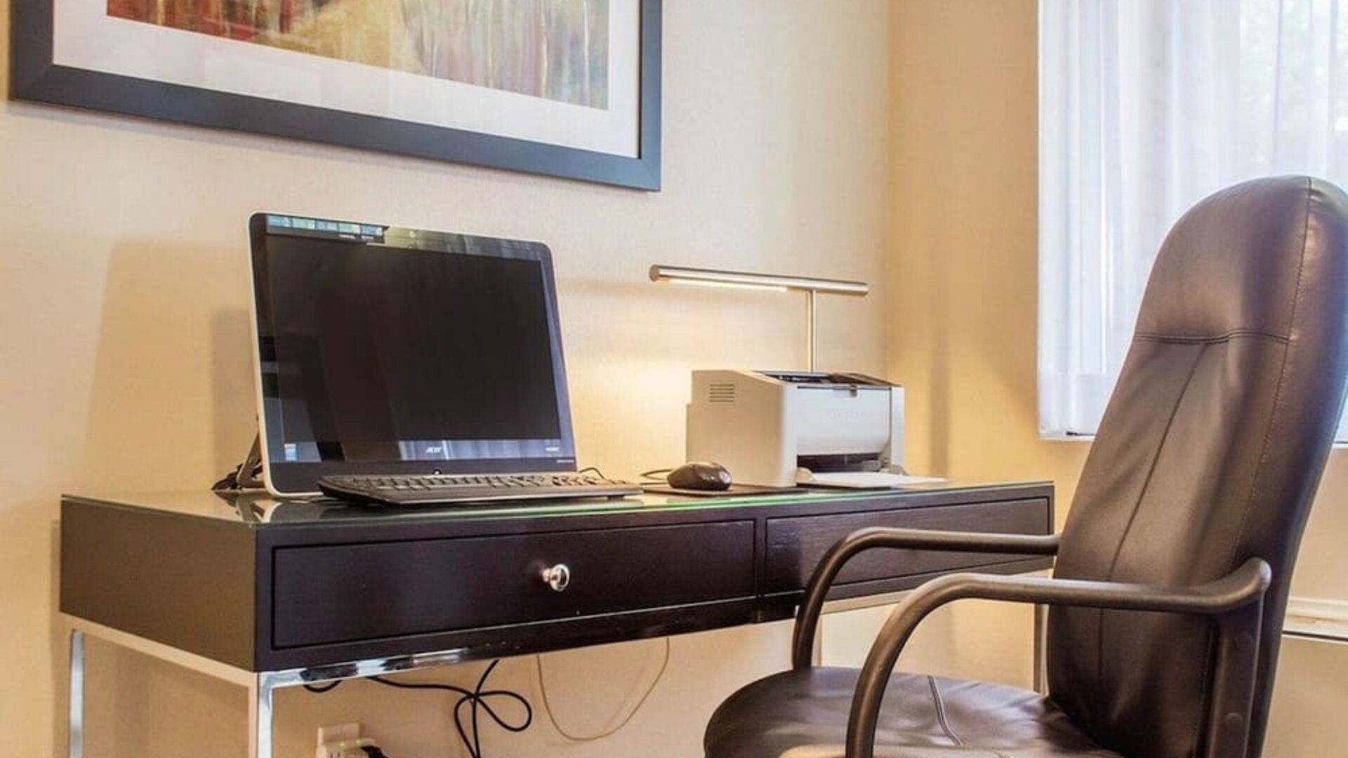 Business center with computer, printer and ergonomic chair at Comfort Inn Brantford.
