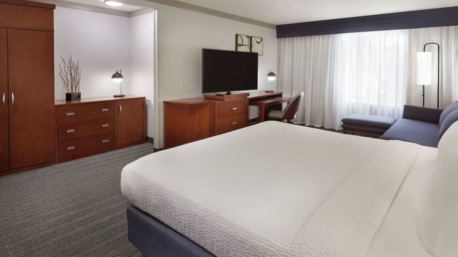 Bright and spacious day use room with TV, work desk, sofa and private bathroom at Courtyard By Marriott Waterloo St. Jacobs.