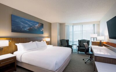 Day use room with TV, work desk and sofas at Delta St. John's Hotel & Conference Center.