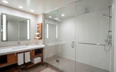 Guest bathroom with shower and free toiletries at Delta Hotel By Marriott Regina.