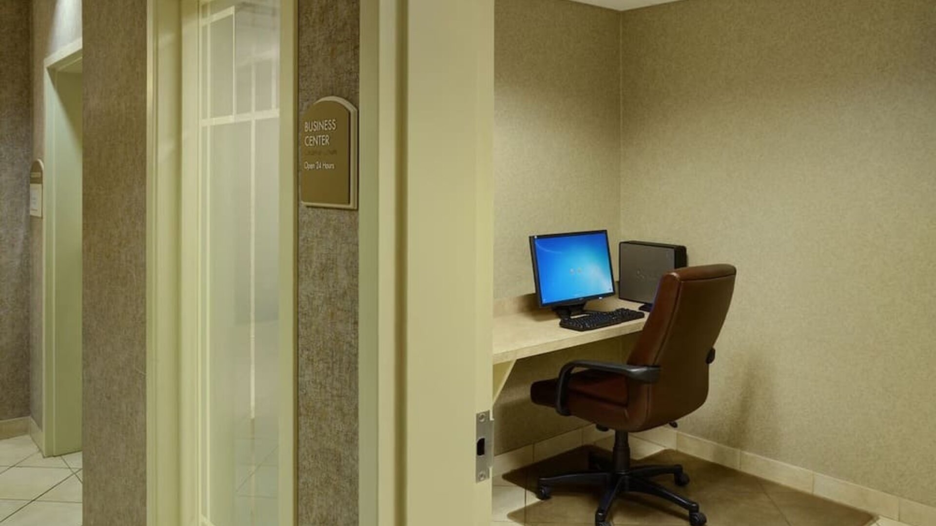 Business center with computer, printer and ergonomic chair at Holiday Inn Express & Suites Medicine Hat.