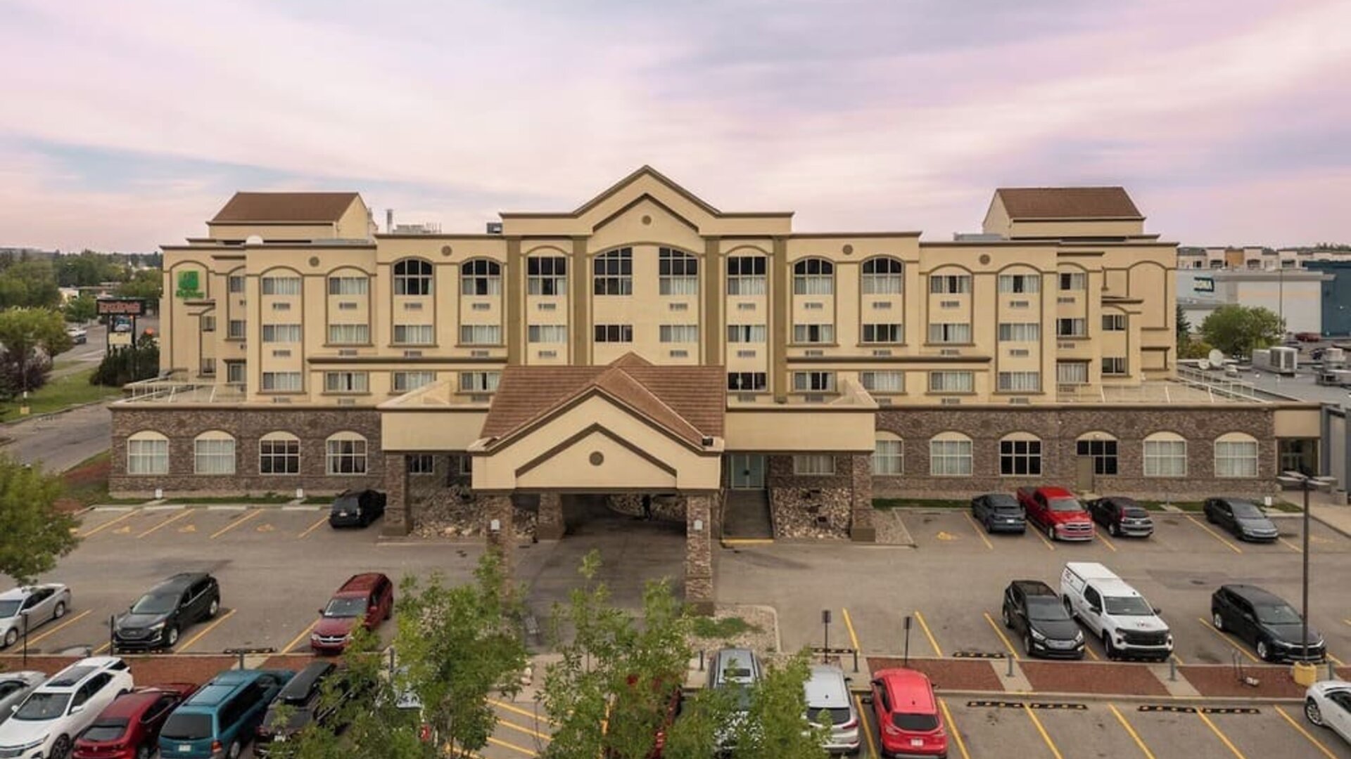 Hotel exterior with parking area at Holiday Inn Lethbridge. 