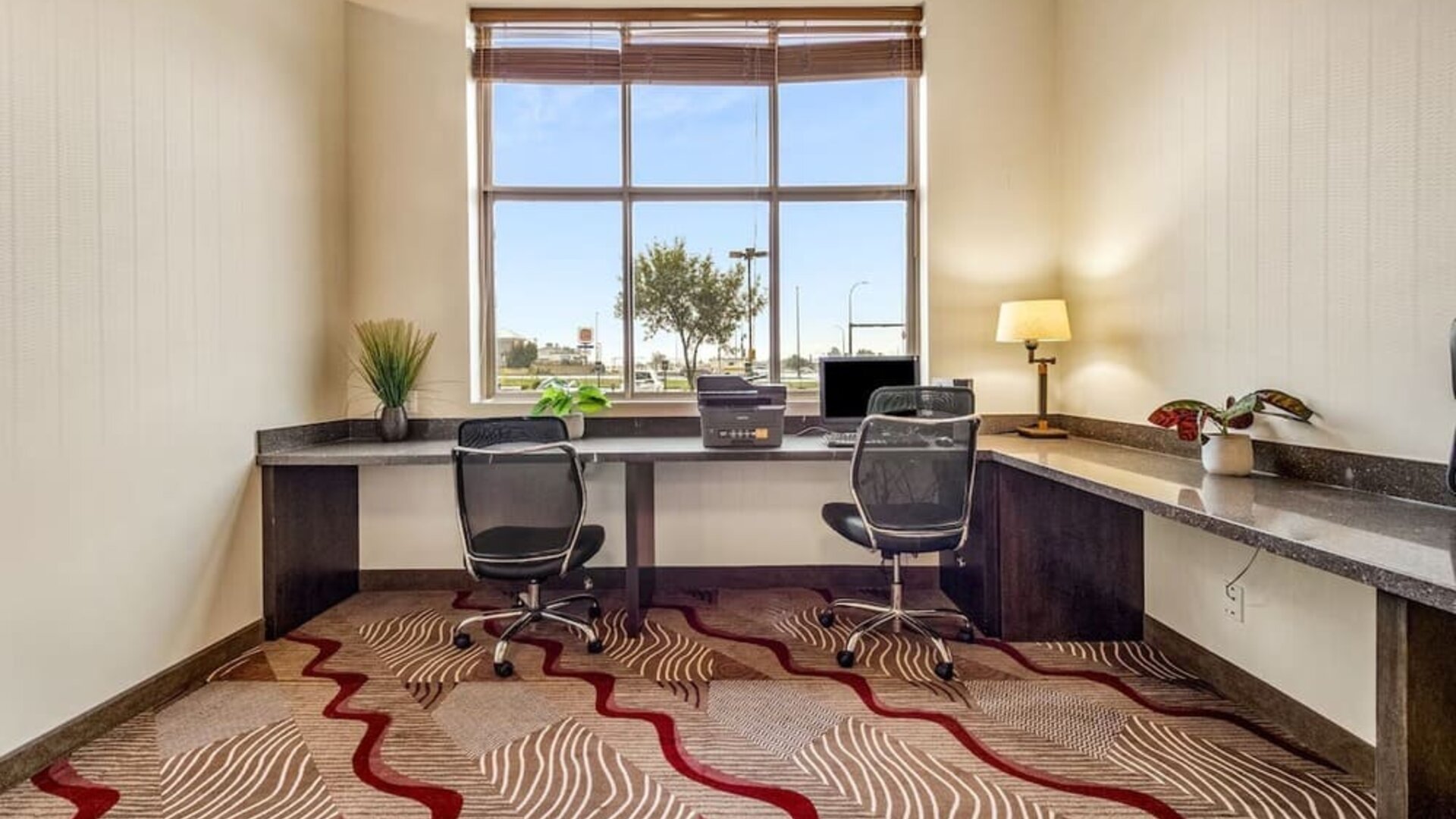Business center with computer, printer and ergonomic chair at Holiday Inn Lethbridge. 