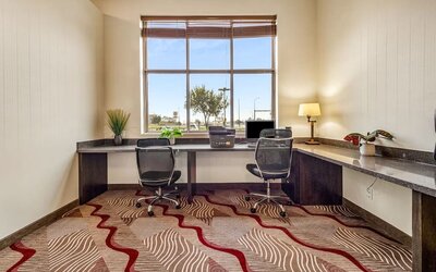 Business center with computer, printer and ergonomic chair at Holiday Inn Lethbridge. 