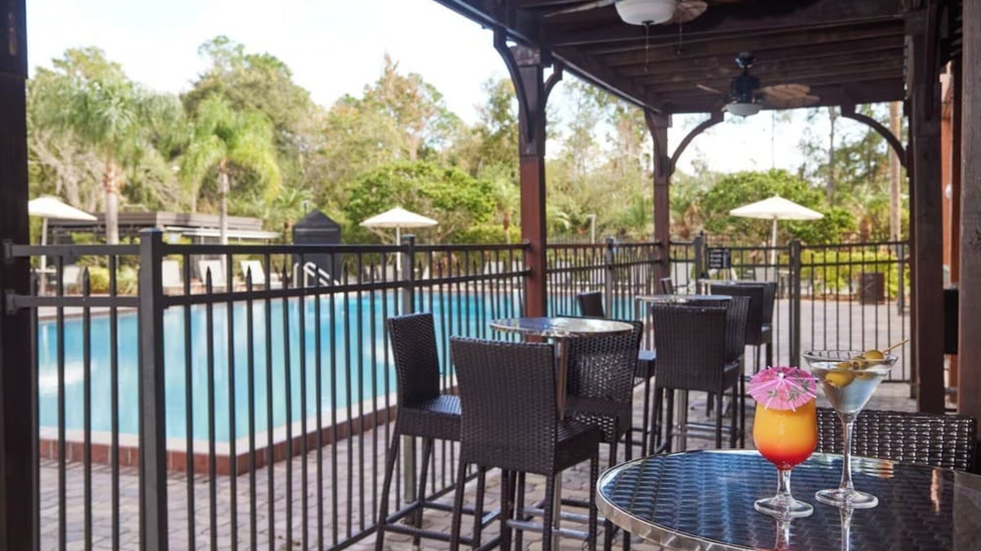 Outdoor seats beside the pool at Holiday Inn Orlando SW - Celebration Area.