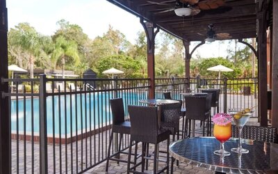 Outdoor seats beside the pool at Holiday Inn Orlando SW - Celebration Area.