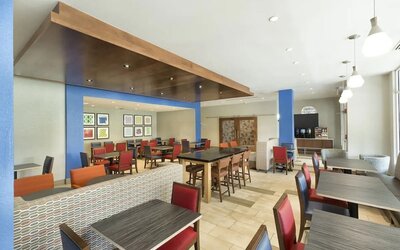 Dining area perfect for coworking at Holiday Inn Express & Suites S Lake Buena Vista.