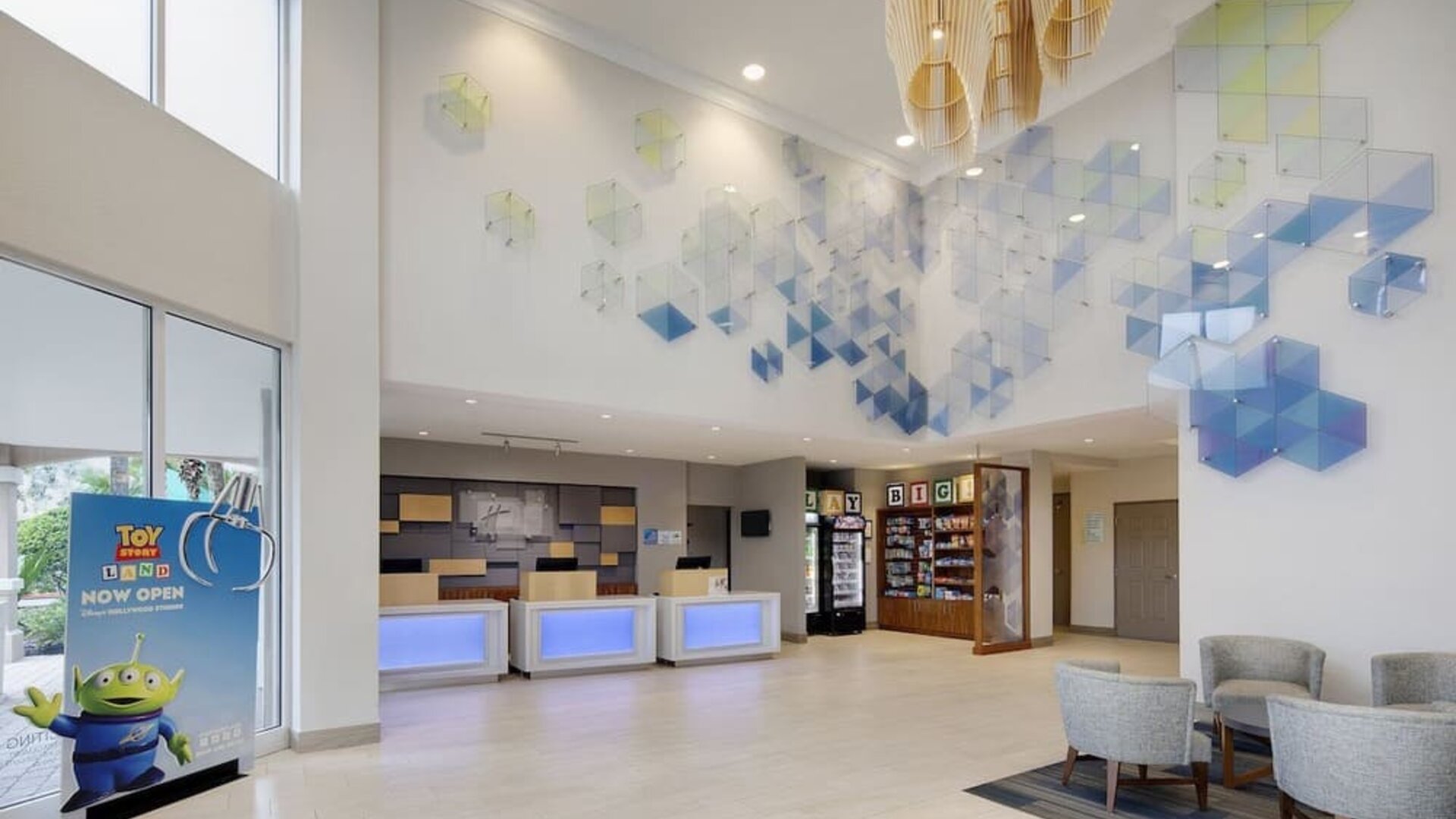 Lobby and coworking lounge at Holiday Inn Express & Suites S Lake Buena Vista.