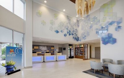 Lobby and coworking lounge at Holiday Inn Express & Suites S Lake Buena Vista.