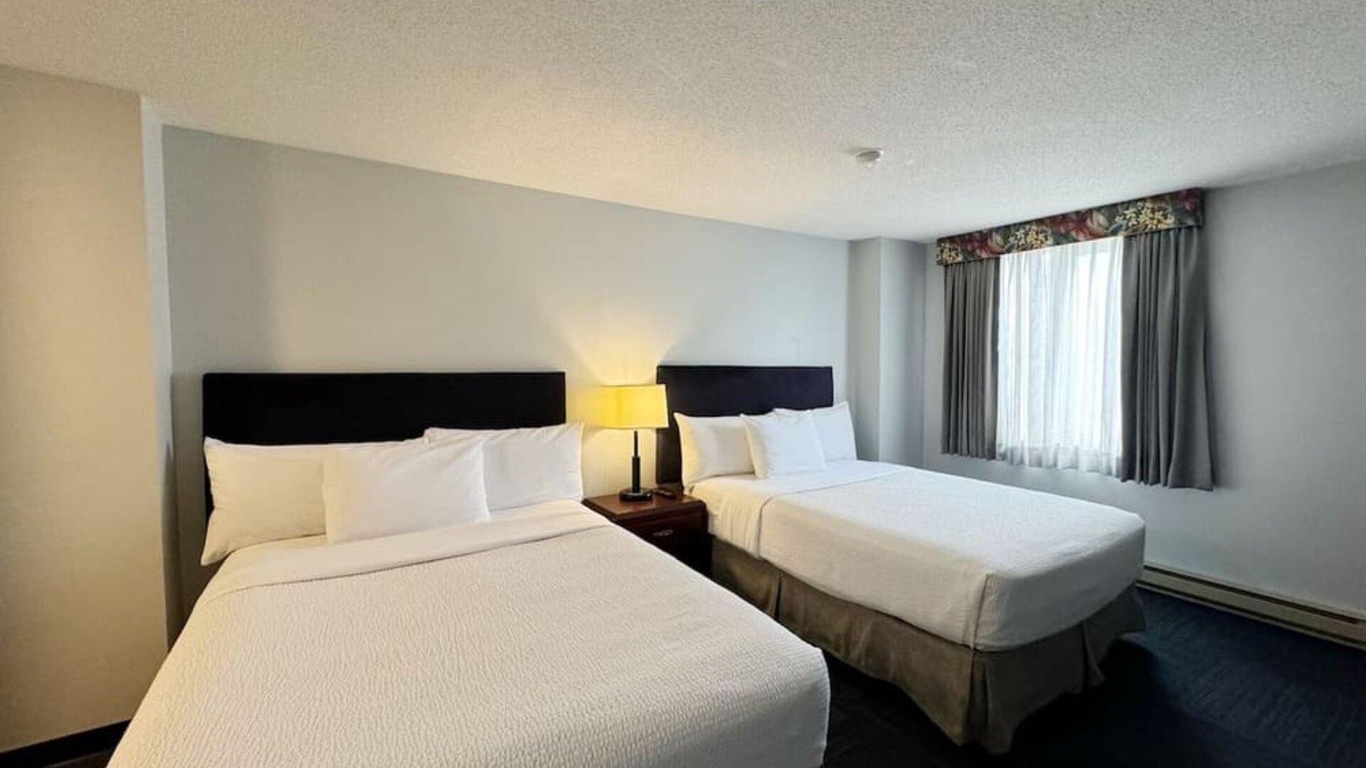 Bright and spacious day use twin room at Divya Sutra Plaza & Conference Centre.