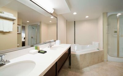 Suite's guest bathroom with hot tub at Best Western Plus Winnipeg Airport.