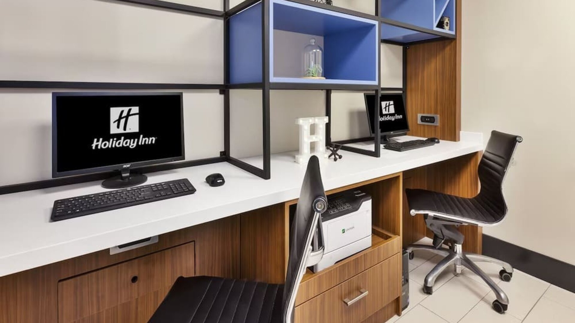 Business center with computers, printer and ergonomic chairs at Holiday Inn St. John's Conference Centre.