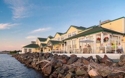 Beautiful hotel terrace with dining area at Rodd Miramichi River.