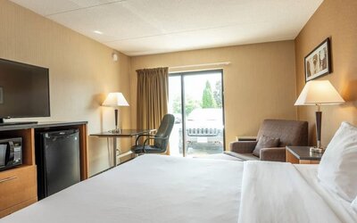 Day use room with work desk, TV and sofa at Comfort Inn Pembroke.