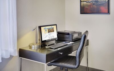 Business center with computer, printer and ergonomic chair at Comfort Inn Gatineau.