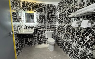 Bathroom with shower  at Days Inn Chinatown NYC.