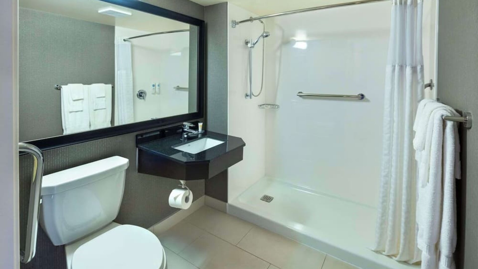 Guest bathroom with shower and free toiletries at Comfort Inn Moncton Magnetic Hill.