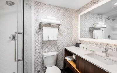 Guest bathroom with shower and free toiletries at Holiday Inn Toronto Airport East.