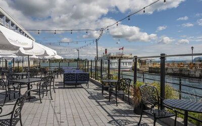 Terrace sitting area with waterfront view at Holiday Inn Kingston Waterfront.