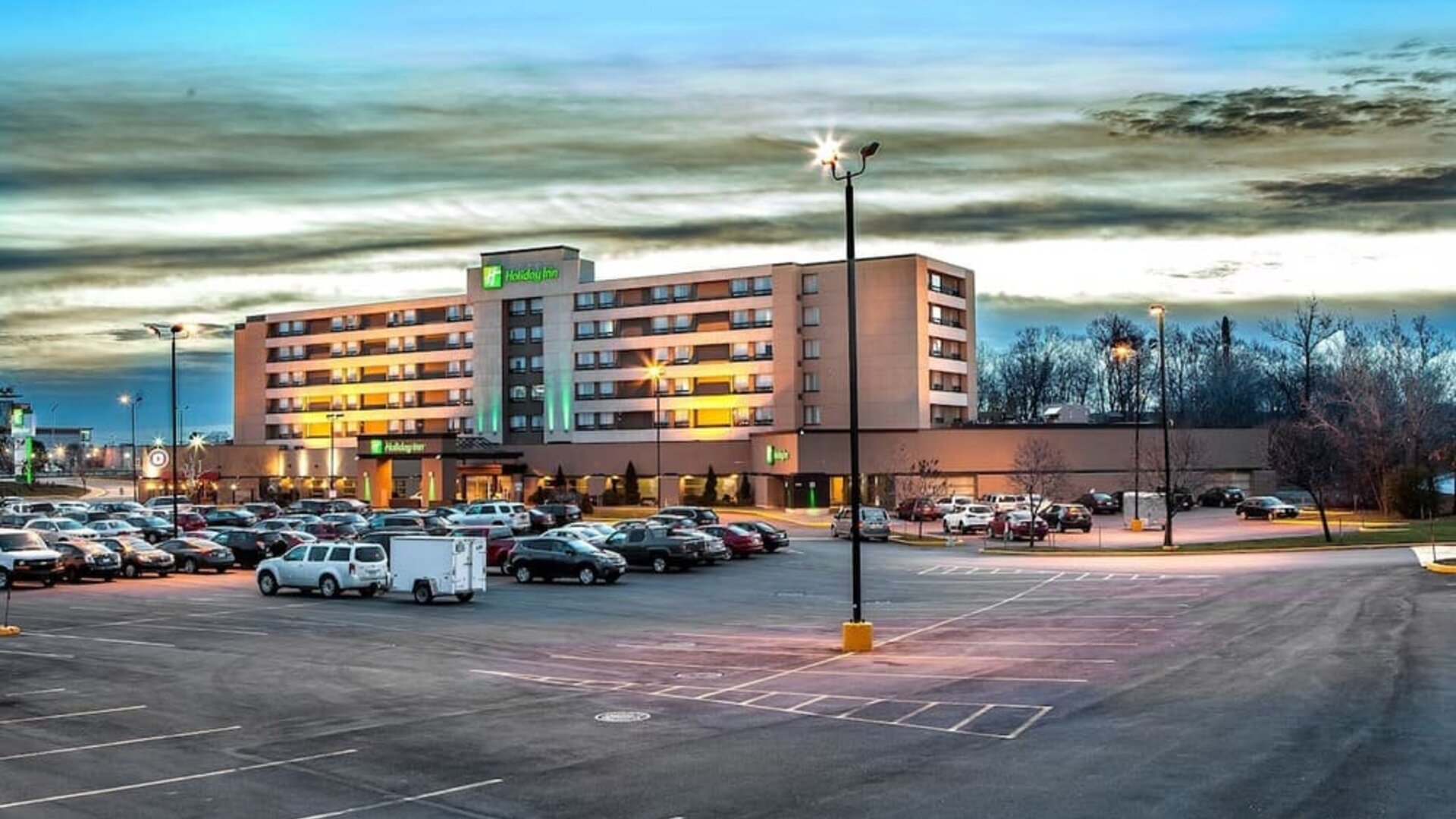 Hotel exterior and parking area at Holiday Inn Laval Montreal.