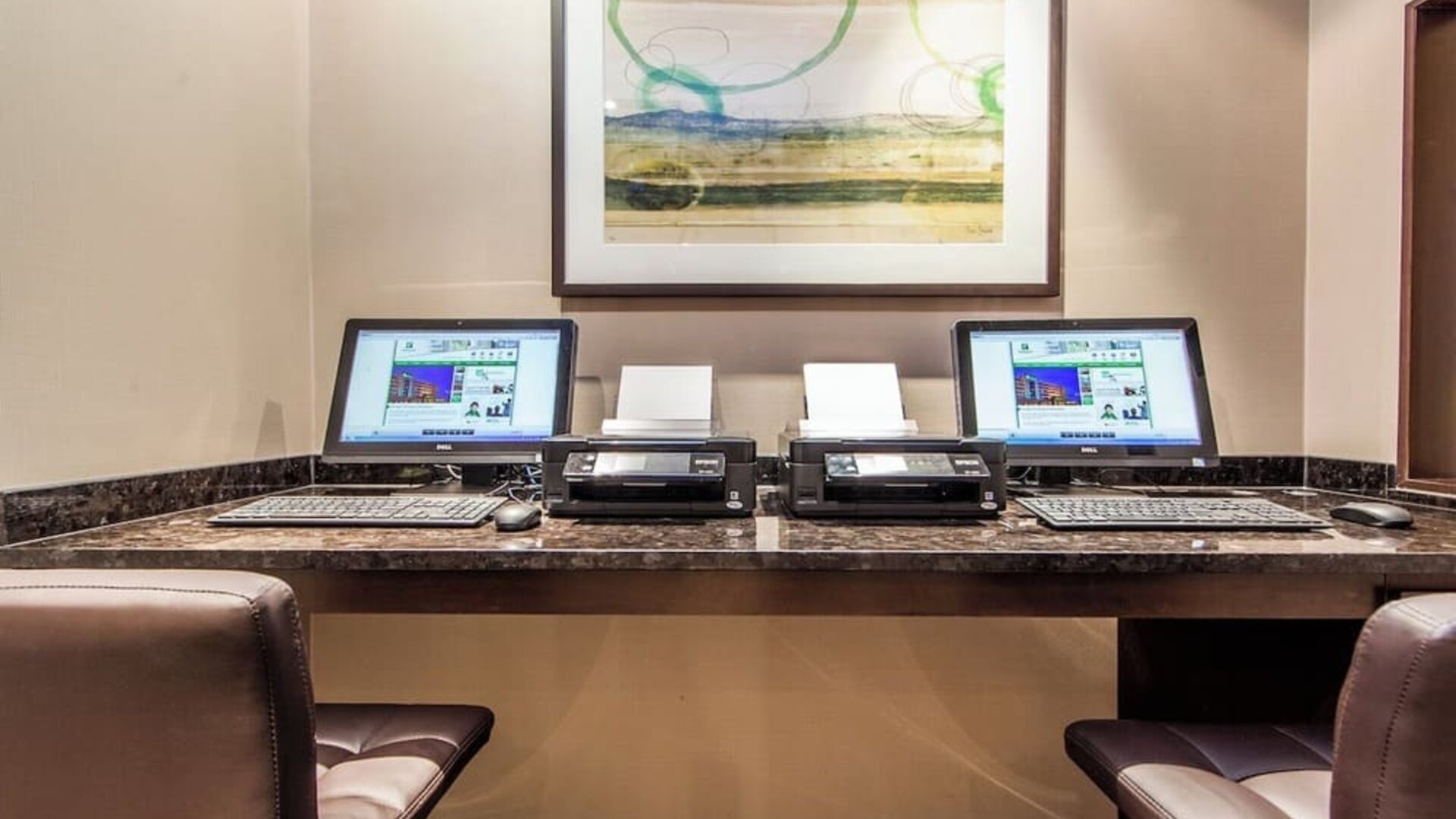Business center with computers, printers and ergonomic chairs at Holiday Inn Laval Montreal.
