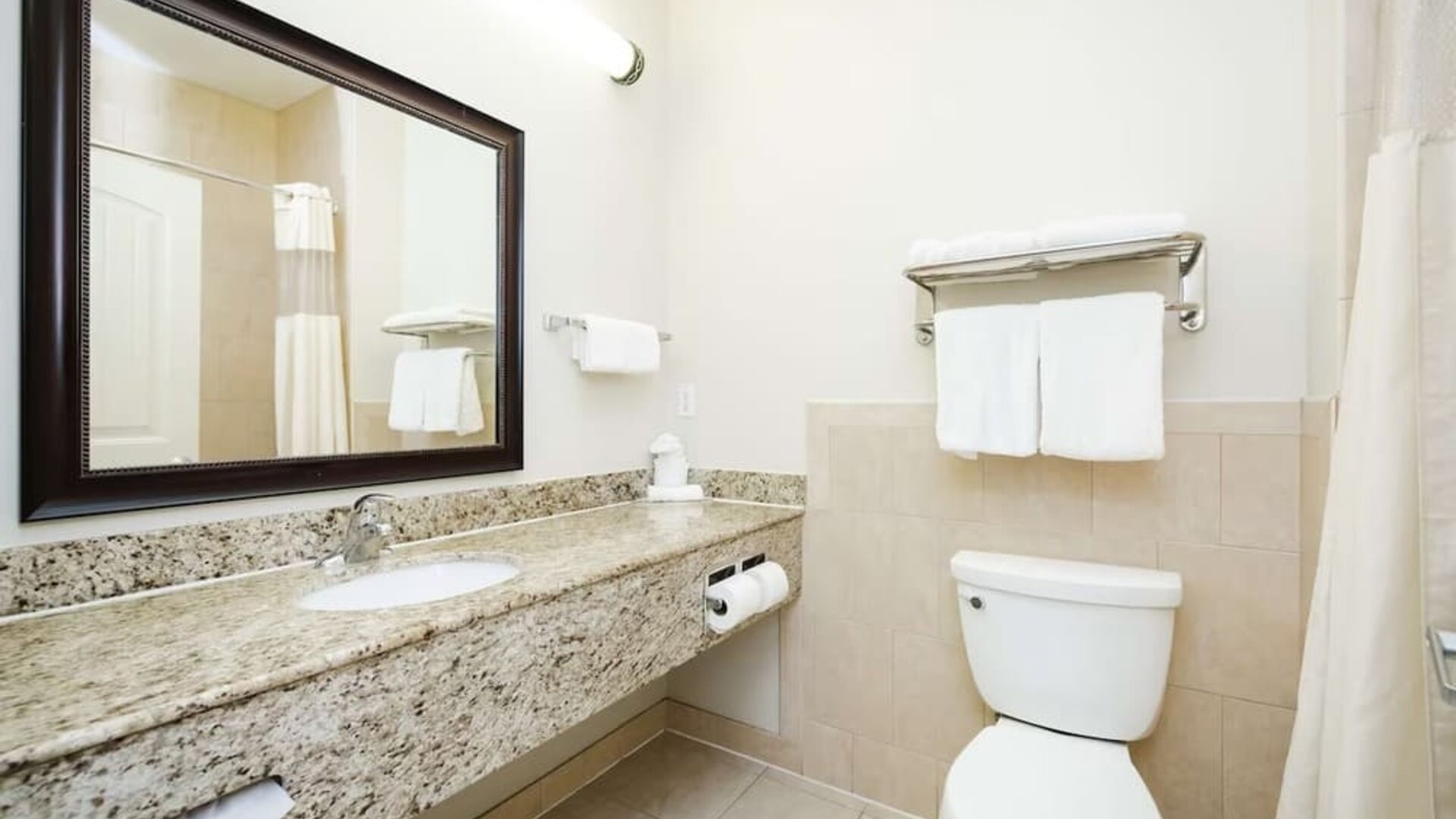 Guest bathroom with shower at Best Western Sugar Land Inn.