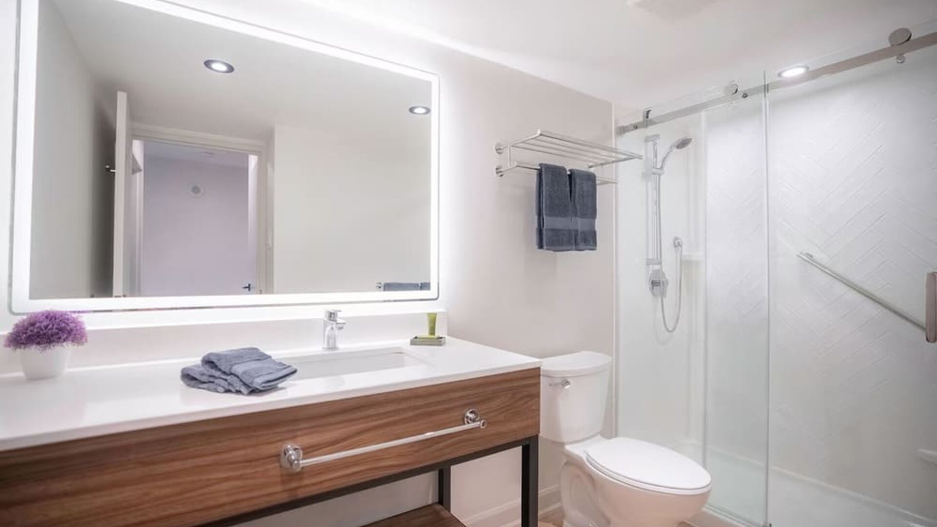 Guest bathroom with shower and free toiletries at Les Suites Hotel Ottawa.