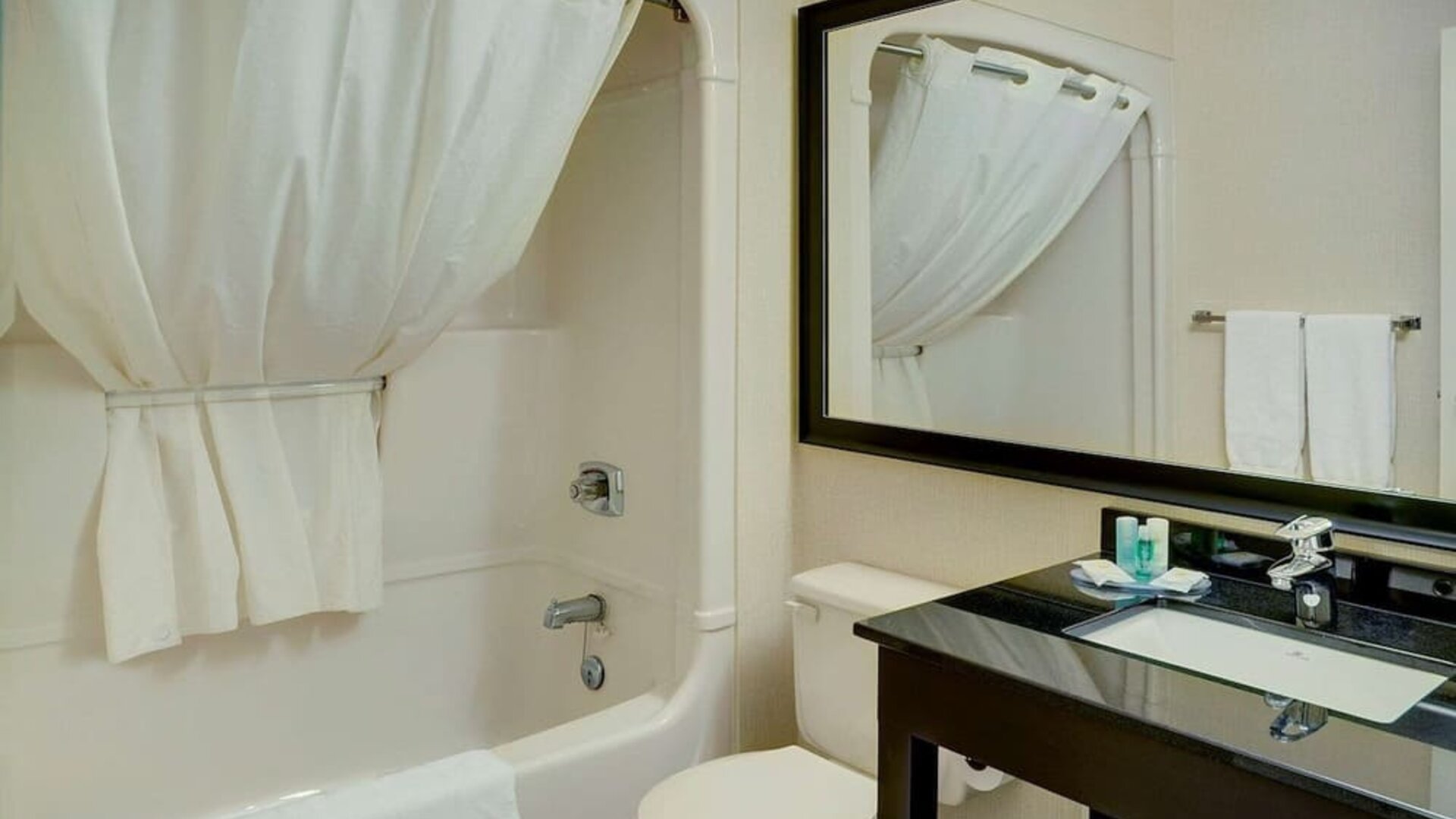 Guest bathroom with tub and free toiletries at Comfort Inn Edmonton West.