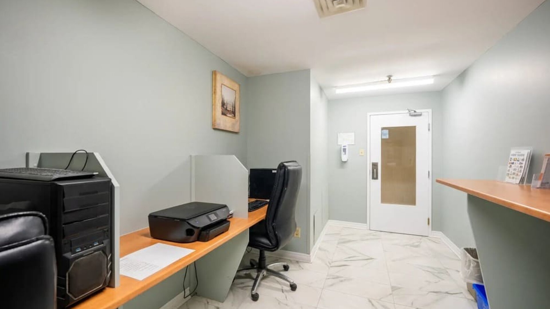 Business center with computers, printer and ergonomic chairs at Halifax Airport Hotel.