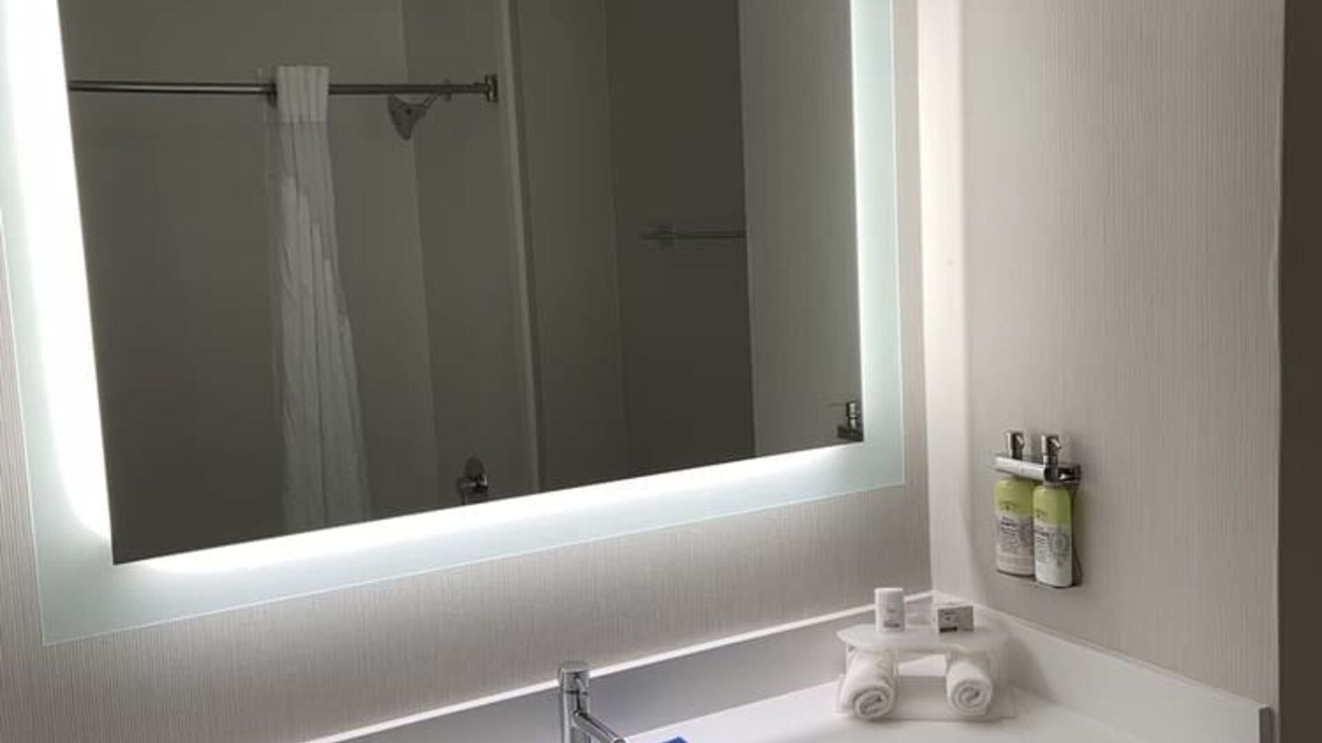 Guest bathroom with shower at Holiday Inn Express & Suites Hermosa Beach.