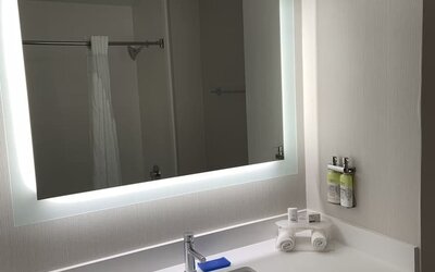 Guest bathroom with shower at Holiday Inn Express & Suites Hermosa Beach.