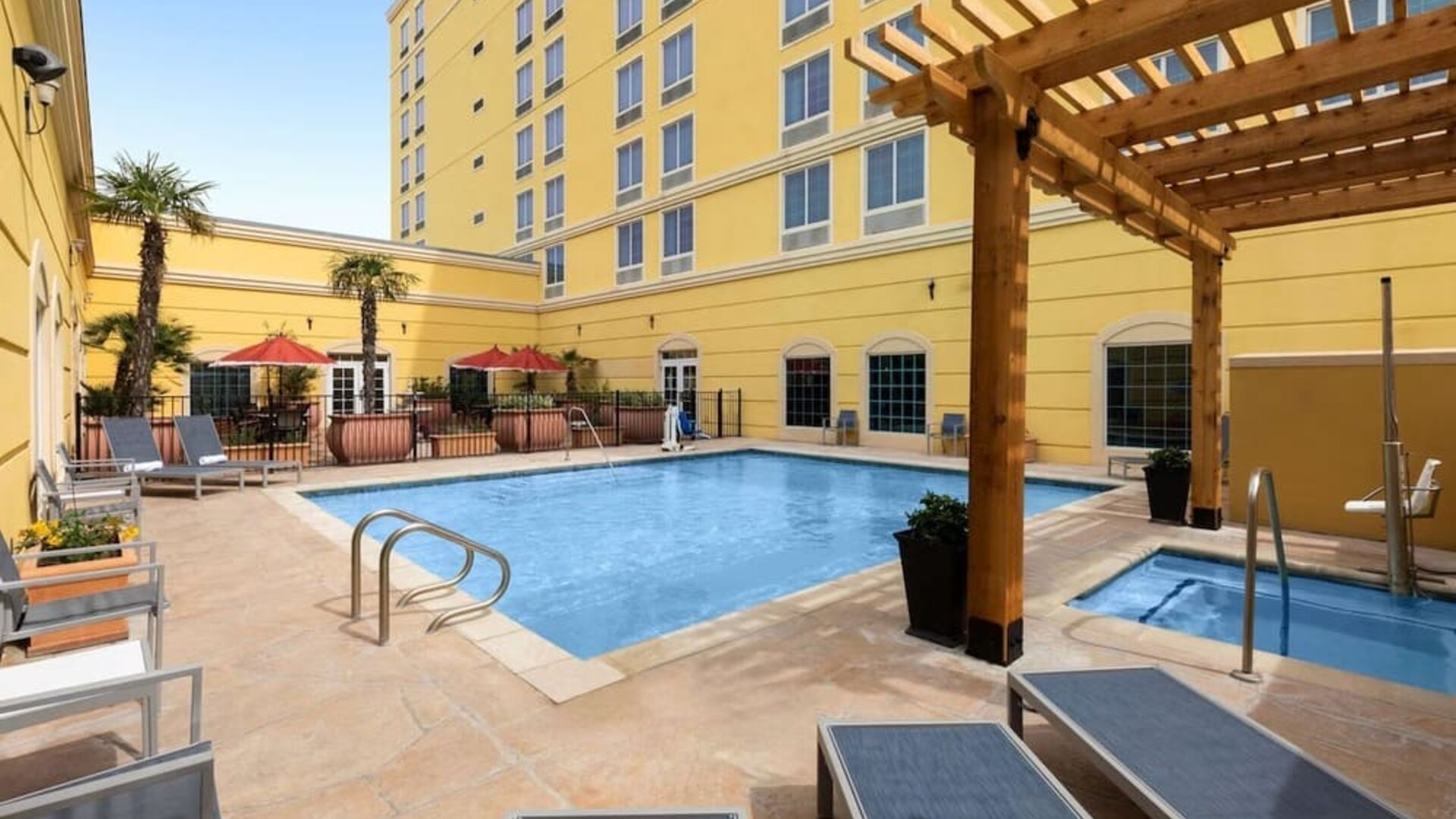 Refreshing outdoor pool and spa tub at La Quinta Inn & Suites San Antonio Medical Center NW.