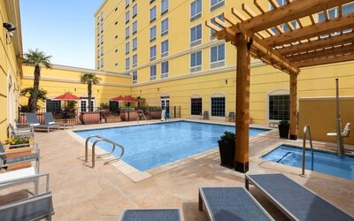 Refreshing outdoor pool and spa tub at La Quinta Inn & Suites San Antonio Medical Center NW.