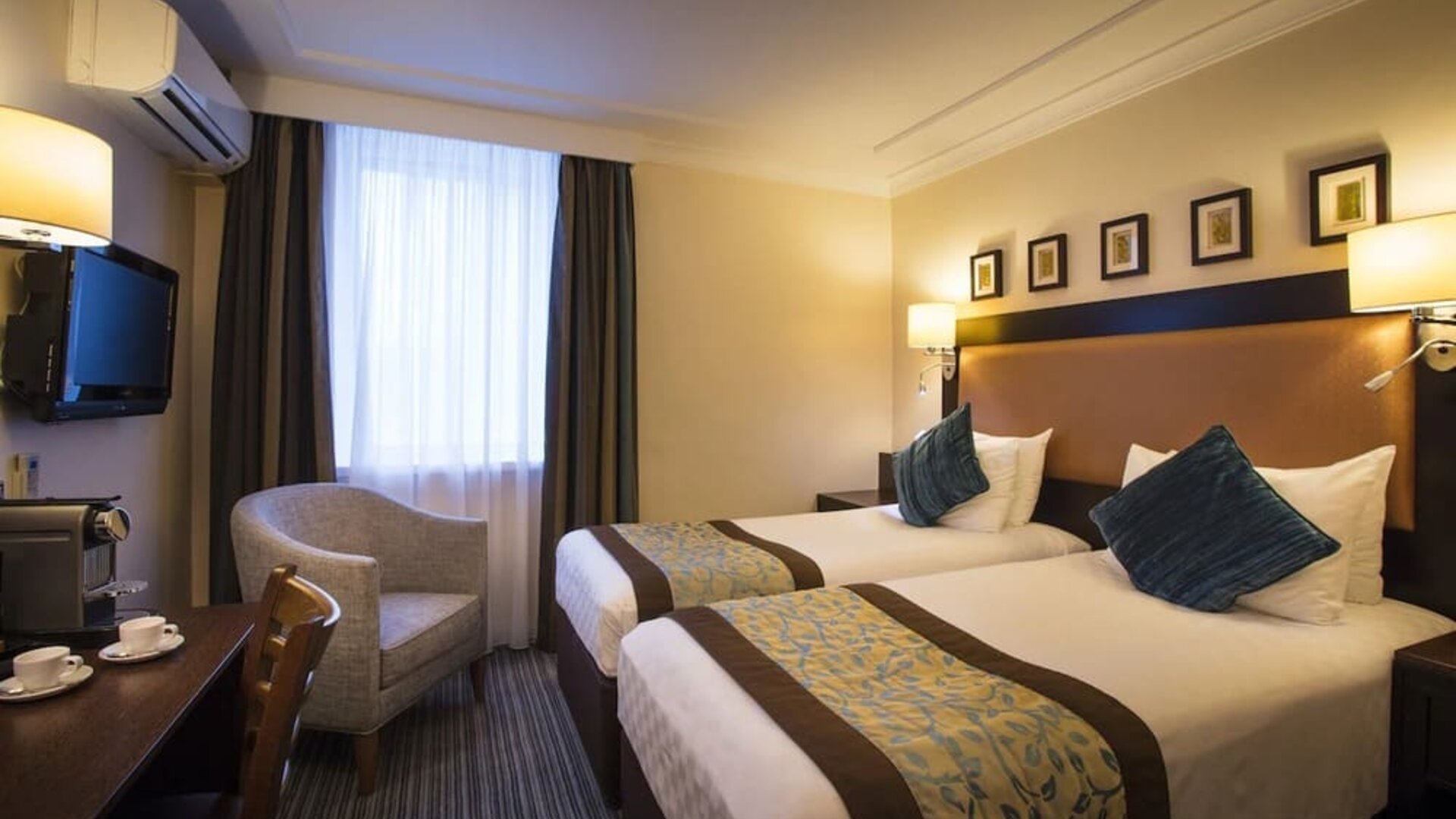 Day use twin room with TV, sofa and coffee maker at Thistle London Heathrow Terminal 5.