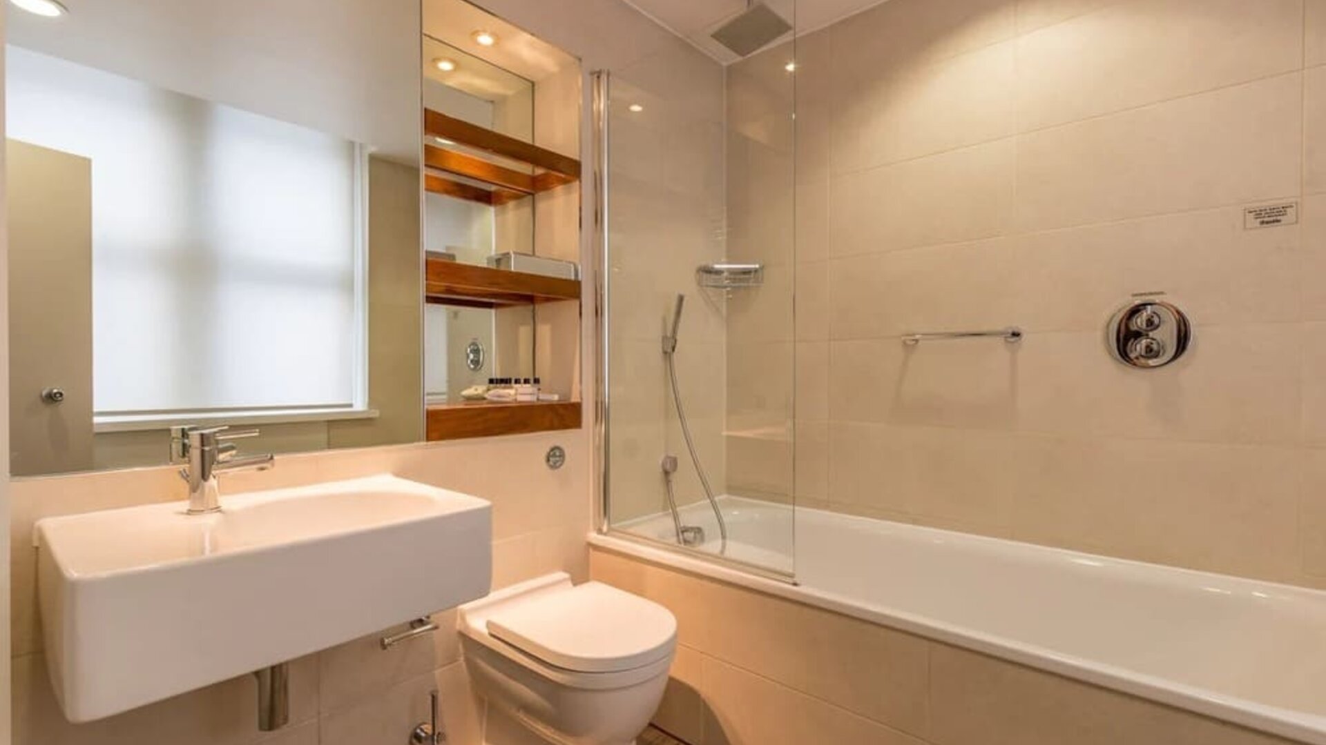Guest bathroom with tub and free toiletries at Thistle Holborn, The Kingsley Hotel.