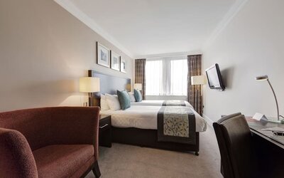 Day use twin room with work desk and sofa at Thistle Royal Trafalgar Square.